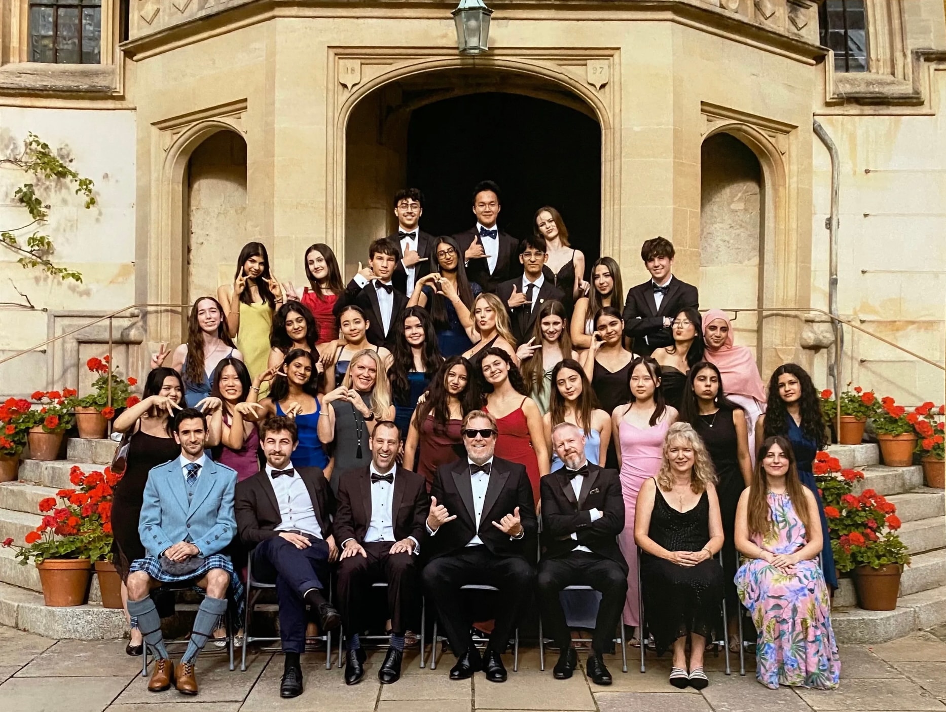 Oxford IQ Academy students and faculty at the Formal Evening, dressed in black tie on the steps of an Oxford college